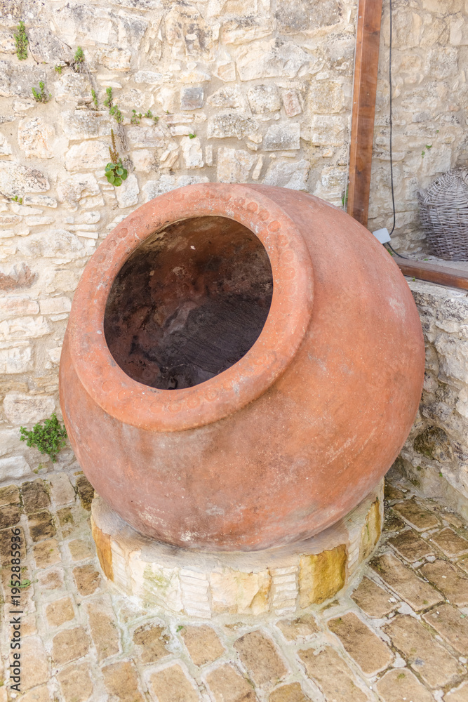 Obraz premium Traditional Stone Village Street with Large Clay Pot, Lofou, Cyprus