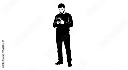 Man in black clothes standing and looking at his smartphone screen with focus
