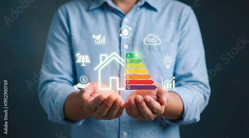 A person holding an illuminated digital display showcasing a comprehensive array of icons representing sustainable energy solutions, smart home efficiency, environmental conservation, renewable power 