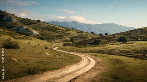 A photo of a dirt road winding through hills.