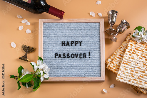 Jewish holiday Passover. Bottle of wine, spring flowers and matzo bread