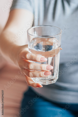 World Water Day. Woman holds glass of clean water in her hands. Health care concept. Drinking water in morning to boost metabolism.