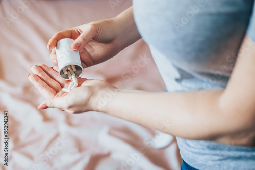 Woman is taking pills. World Health Day. Hands holding medical bottle with capsules. Health care concept.