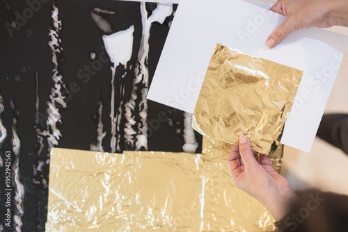 Billede på lærred Hands gently apply shimmering gold leaf to a stunning piece of luxury furniture
