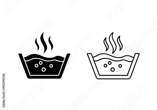 Two steaming bowls of hot food are placed side by side on a table indoors.
