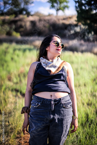 A close up head shot portrait of a preppy, young, beautiful, confident and attractive Mexican woman. Enjoying her happy life. Happy young girl