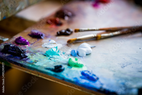 Artist palette with blue paint tube and brush. Preparation for painting project.