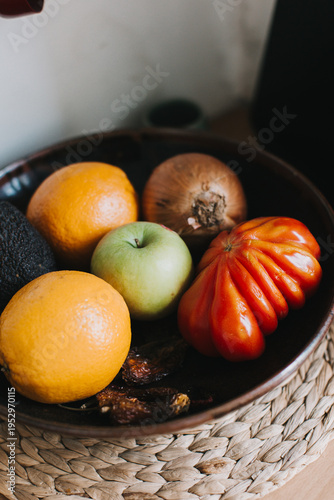 wooden fruit bowl with apples pears onions and avocadoes, concept of simple natural healthy ingredients