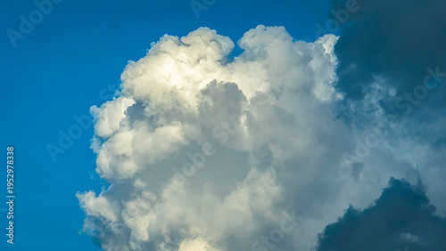 Towering white cumulus clouds against blue sky