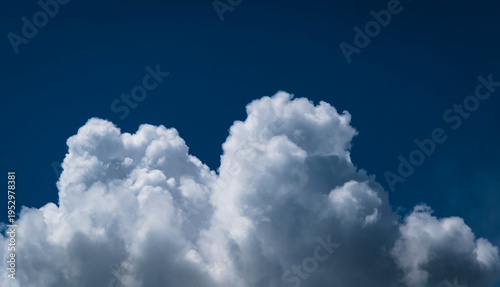 Towering white cumulus clouds against blue sky