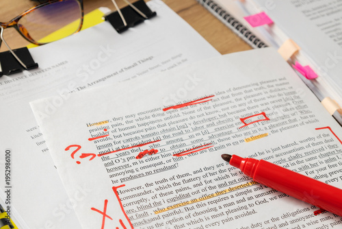 Fotografie Detailed view of annotated pages and pen on desk illustrating professional docum