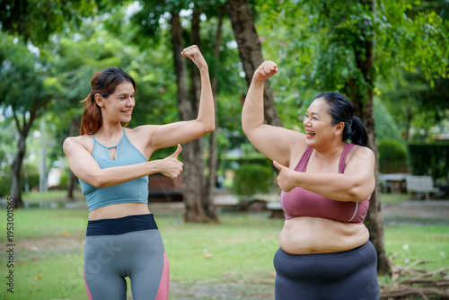 Tableau sur toile Confident plus size woman in sportswear smiling and exercising with personal trainer in the park, Body positivity and healthy lifestyle concept