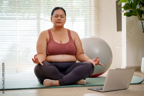 Free Download Yoga meditation home workout online class laptop living room exercise ball plus size woman mindfulness calm focus as adult sits cross legged on mat by window in virtual session - GFXLoad