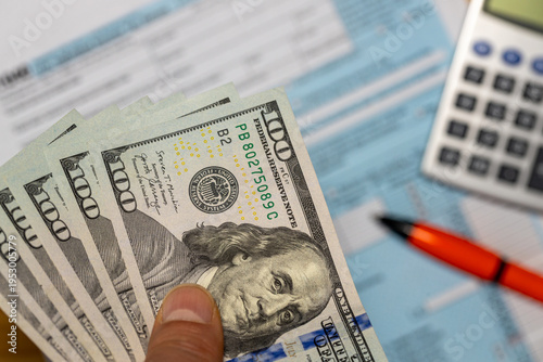 United States. US Income Tax Return. Financial and business Concept. American National Colors and the word TAX. Tax Form, Money, and Calculator.. closeup. Flat lay