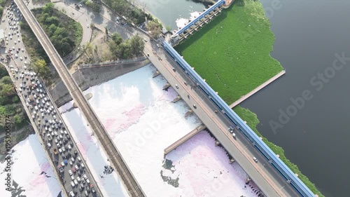 Aerial 4k view of Pollution in Yamuna River, Foam in river water and heavy traffic jam at Kalandi Kunj, Delhi, India