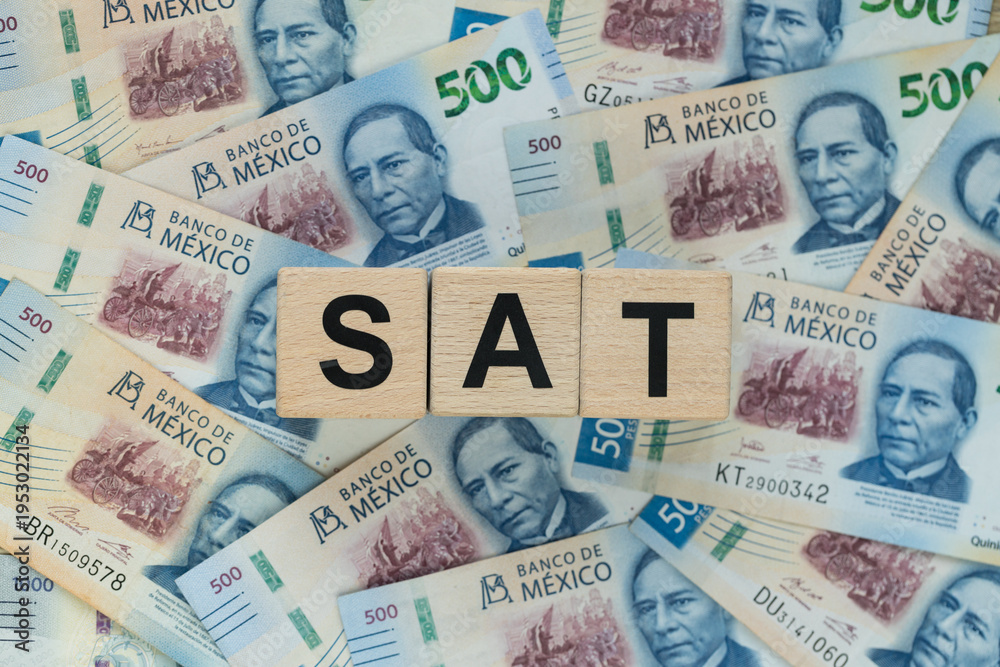 Obraz premium SAT In Mexico, an abbreviation for personal income tax. A financial concept. Taxes in Mexico, written on wooden blocks, Mexican pesos, business background. Close up
