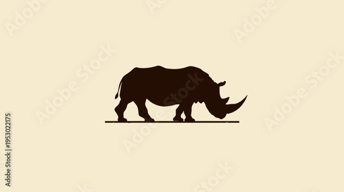 A silhouetted rhino in dark brown against a beige background, standing on a dark line