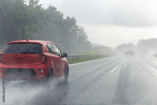 Back tail view of many cars driving fast on wet highway road after rain in Europe. Automobile accident vehicle rush hour collapse. Transportation vacation seasonal stuck. Low visibility bad weather