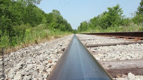 Train rail viewpoint. Train tracks in the countryside. Summer in Ontario, Canada. HD video.