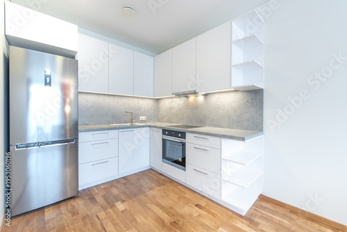 Modern Home Kitchen With Stainless Steel Appliances and Wooden Flooring