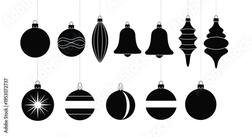 Assorted black and white holiday ornaments hanging in a festive display