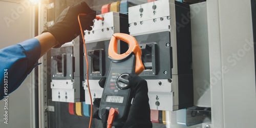 Fotografija Electrical equipment maintenance service engineer Engineers carry AC voltmeters to check voltage at breaker terminals and inspect switchgear