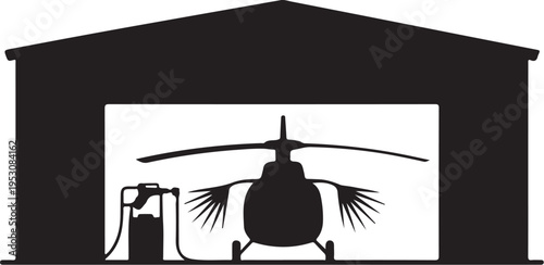 Black helicopter refueling at gas pump in hangar