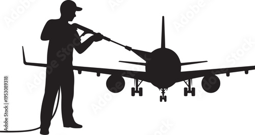 Man in silhouette washing airplane with pressure washer