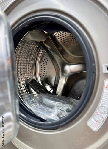 Closeup Open Washing Machine Drum Showing Stainless Steel Interior, Glass Door, Rubber Gasket And White Exterior, Empty Tub Bathed