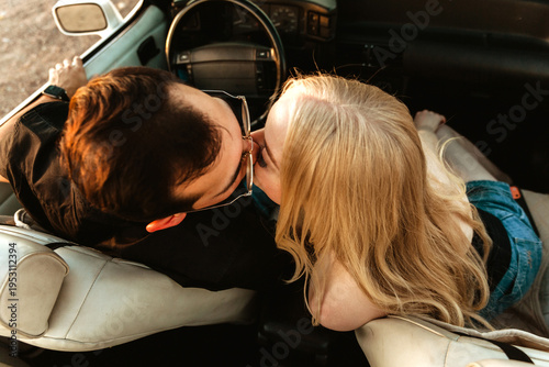 young couple in car kissing