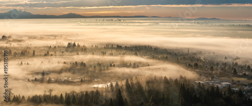 Sunrise Fog Over Burnaby Residential Valley With Distant Vancouver Skyline and Mountains in BC, Canada