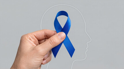 Hand holding blue ribbon symbolizing mental health awareness  