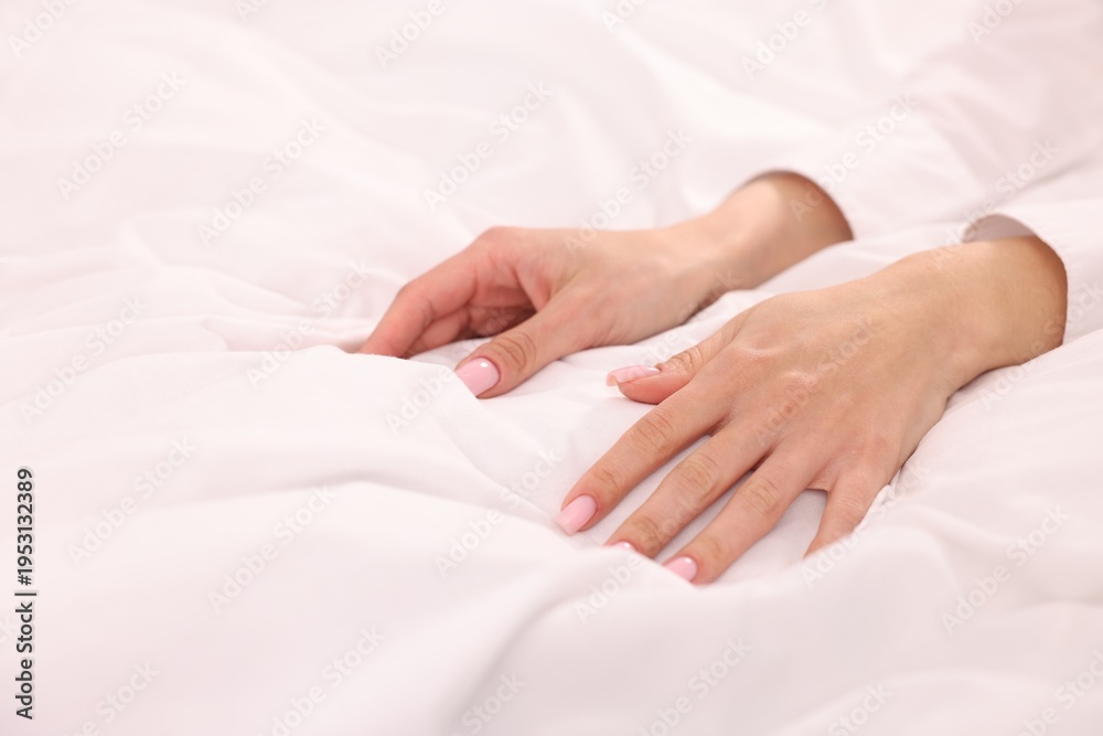 Fototapeta premium Woman touching fresh bed linens, closeup view