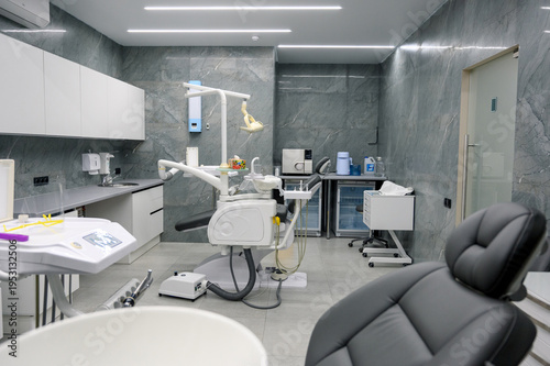 Modern dental clinic interior with dental chair and equipment visible
