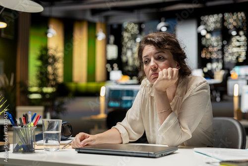 Quadro su tela Demotivated businesswoman, sighing, pushing limits, late at night, being in a mental haze and troubled by workload and life choices