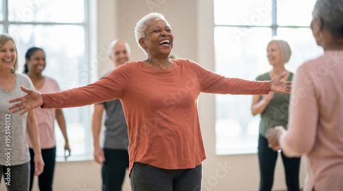 Wallpaper Mural Happy senior woman with arms outstretched leading a group fitness class in a bright studio Torontodigital.ca