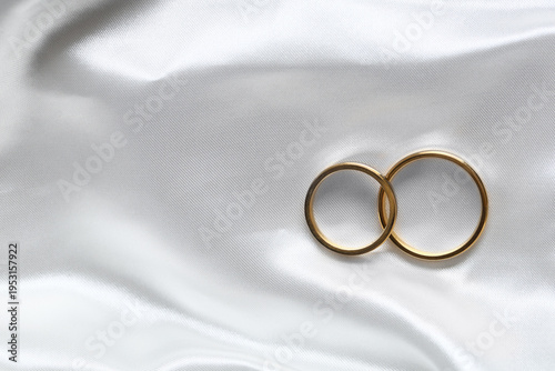 Golden wedding rings on whi...