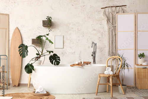 Fotografija Interior of modern bathroom with bathtub, chair and folding screen