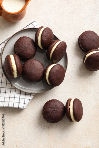 Tableau sur toile Sweet chocolate whoopie pies on light background, top view