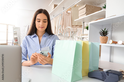 Female seller with mobile p...