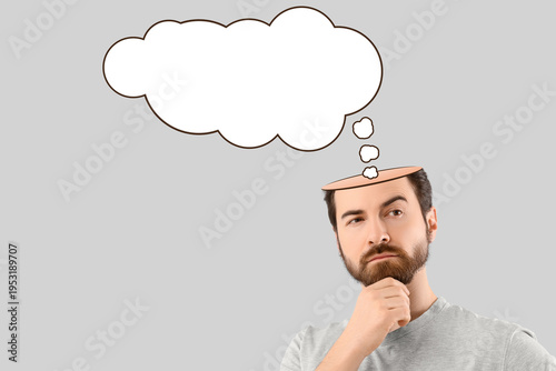 Thoughtful young man scratc...