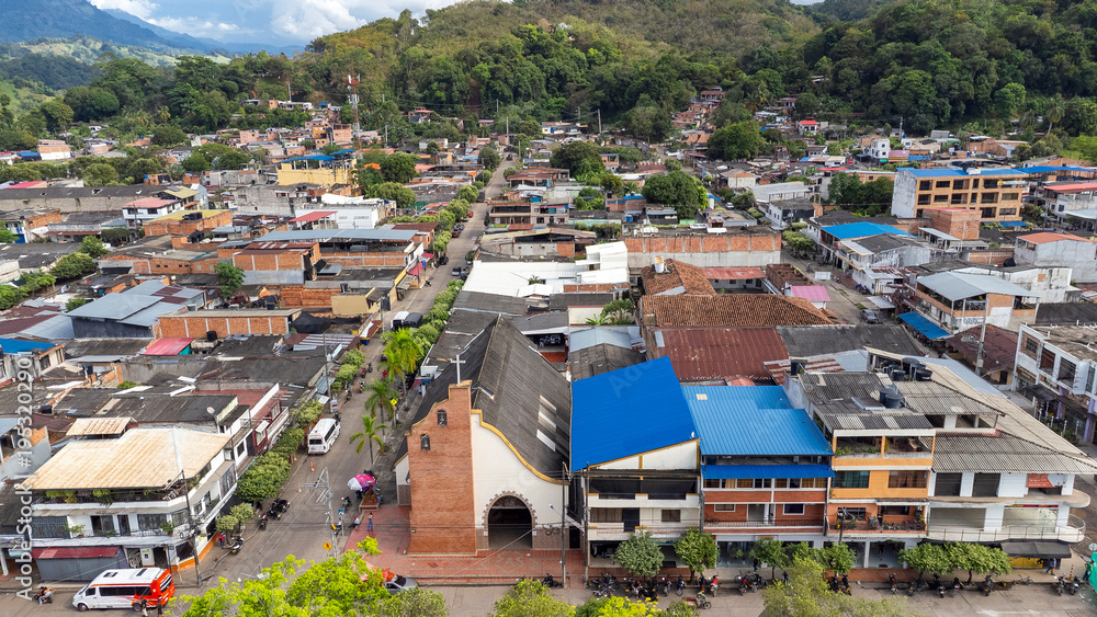 Fototapeta premium Cimitarra, Santander - Colombia. February 25, 2026. Panoramic drone view of the town's main church.