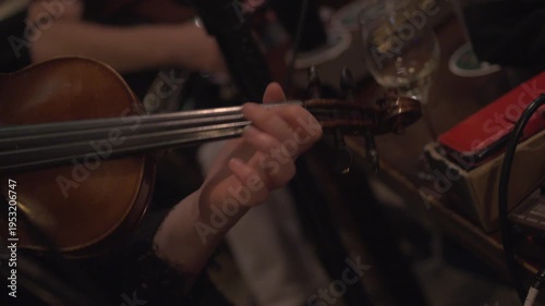 Fiddle violin musician playing notes in Irish pub traditional  music session