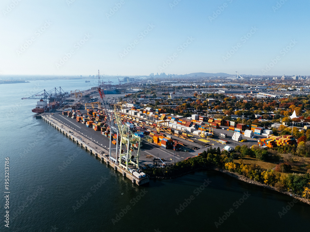 Naklejka premium Aerial view of port industrial tanks and container yard near river in Montreal, Canada. g.