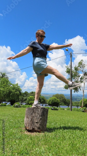 Woman balancing on the tree trunk