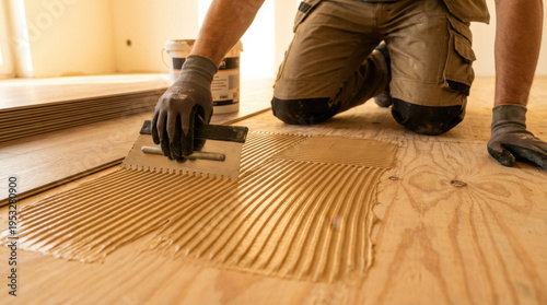 Professional Carpenter Laying Wooden Floor with Trowel