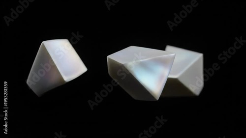 White 3 D geometric shapes rotating on black background