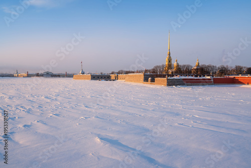 Peter and Paul Fortress and Vasilievsky Island from the Trinity Bridge over the Neva River on a sunny winter morning with clouds, St. Petersburg, Russia