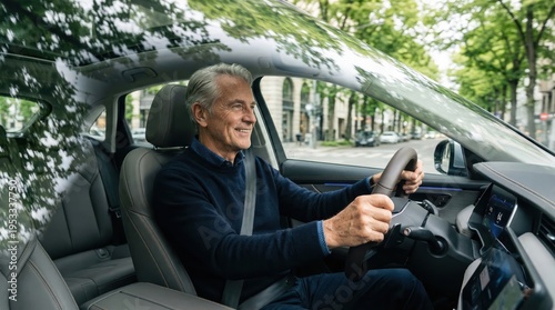 Senior man smiling behind the wheel while driving a car through the city. Active lifestyle, male driver, urban commute.