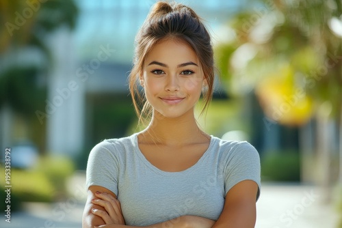 Portrait of a young beautiful woman in casual clothes standing outside an office center and campus, crossing her arms over her chest and smiling confidently at the camera, Generative AI